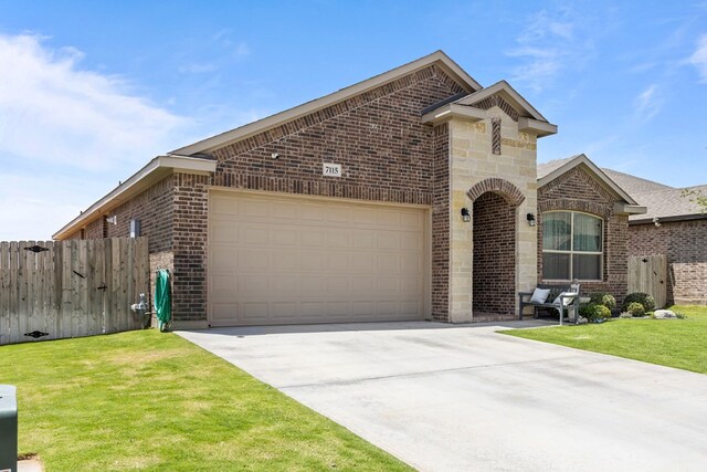 7115 Saguaro Rd, Odessa, TX 79765 - view of front of house with brick siding and an attached garage