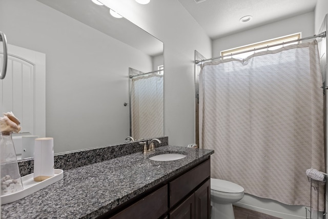 bathroom with toilet, vanity, and shower / bathtub combination with curtain