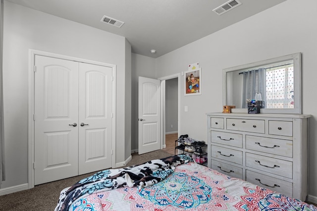 carpeted bedroom with a closet and baseboards