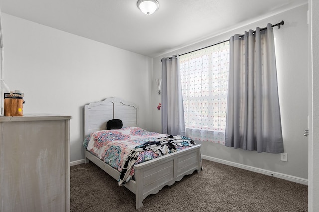 carpeted bedroom featuring baseboards