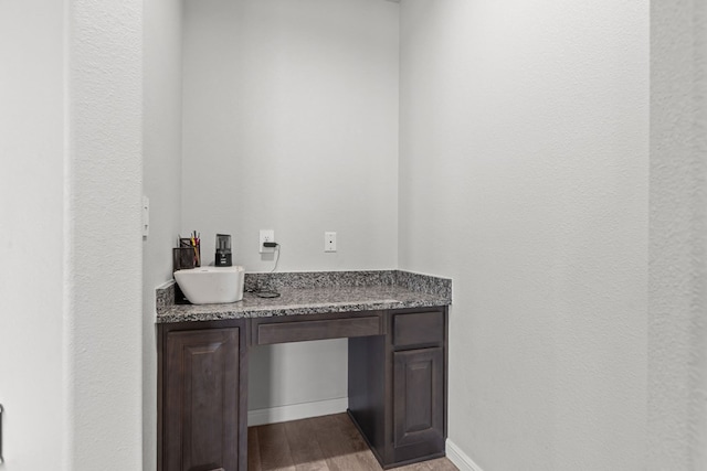 bathroom featuring wood finished floors, vanity, and baseboards