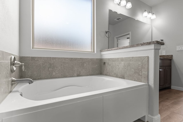 full bathroom with a bath and vanity