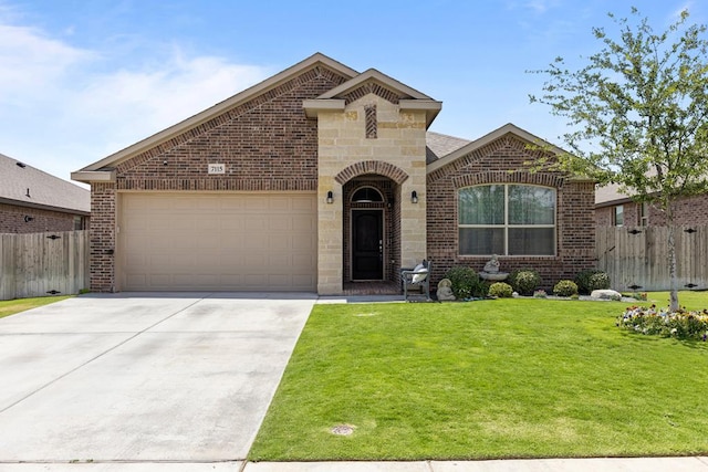 7115 Saguaro Rd, Odessa, TX 79765 - french country home featuring brick siding, a garage, concrete driveway, and stone siding