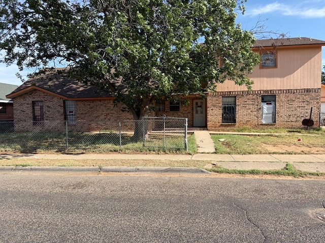 1140 Clifford St, Odessa, TX 79763 - view of front of home with brick siding and a fenced front yard