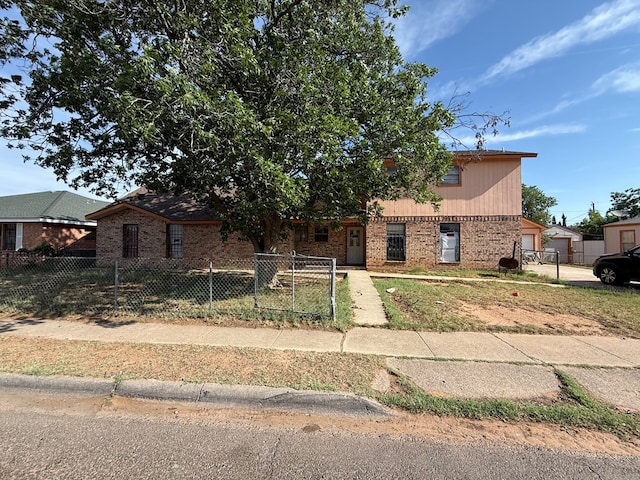 1140 Clifford St, Odessa, TX 79763 - view of front of house featuring brick siding and a fenced front yard