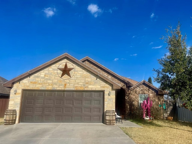 ranch-style home featuring a garage, stone siding, concrete driveway, and fence