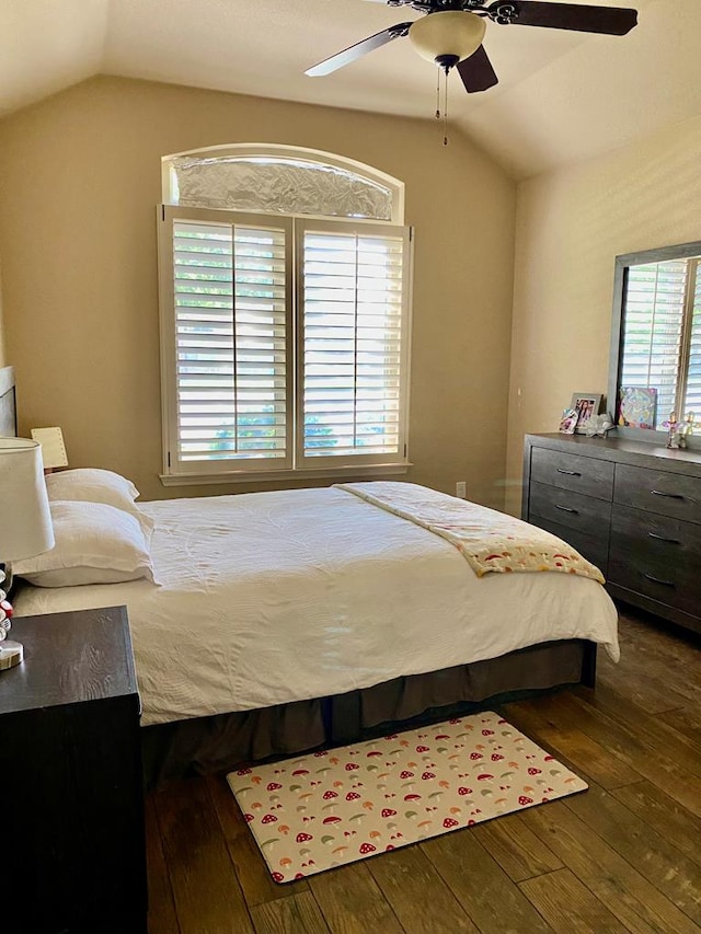 bedroom with ceiling fan, lofted ceiling, and hardwood / wood-style floors