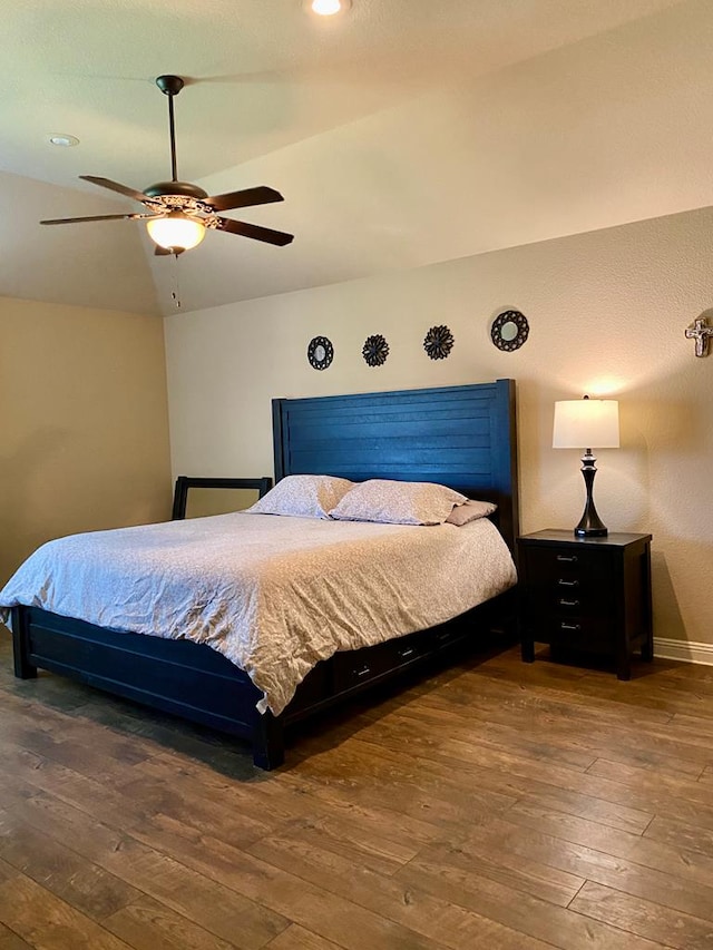 bedroom featuring baseboards, a ceiling fan, and hardwood / wood-style flooring