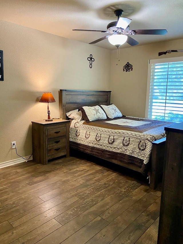 bedroom with baseboards, ceiling fan, and hardwood / wood-style flooring