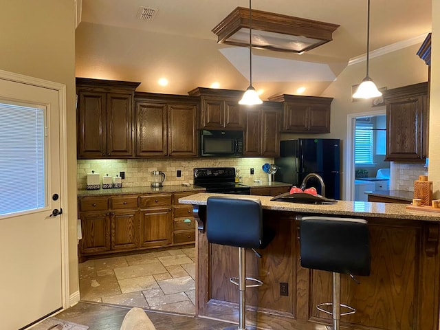 kitchen with visible vents, decorative backsplash, a sink, and black appliances