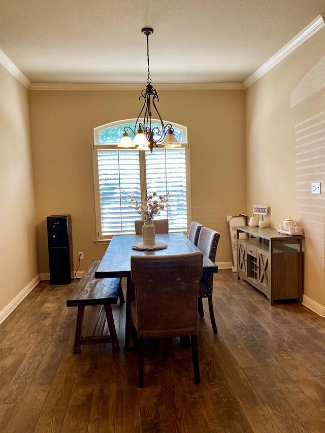 dining space with baseboards, an inviting chandelier, ornamental molding, and hardwood / wood-style flooring
