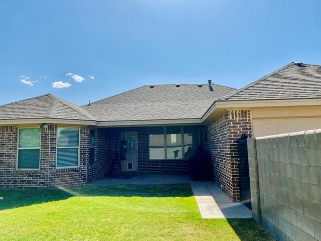 1508 Cedar Ln, Andrews, TX 79714 - exterior space with brick siding, a patio, an attached garage, a front yard, and roof with shingles