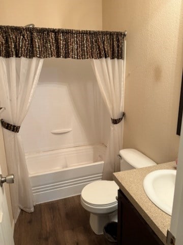 bathroom featuring vanity, shower / tub combo, wood finished floors, and toilet