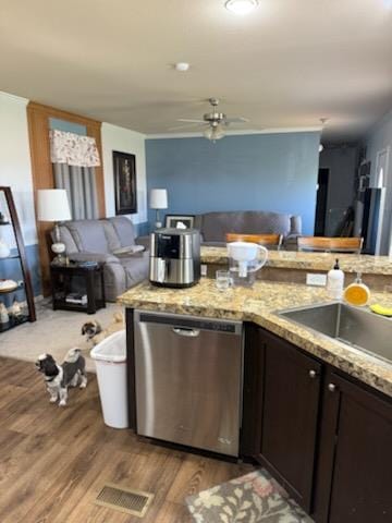 kitchen featuring dark brown cabinets, open floor plan, light wood-style flooring, and dishwasher