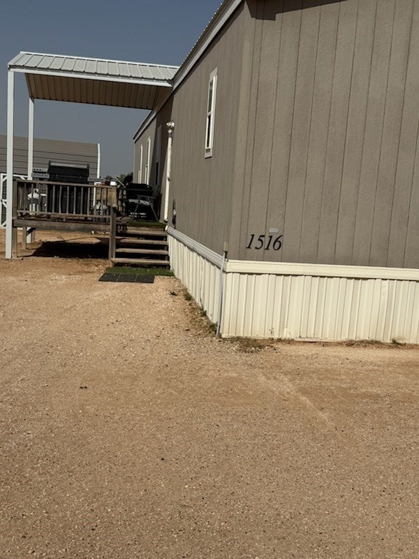 view of home's exterior with a wooden deck