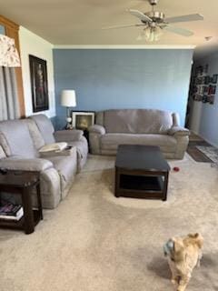 carpeted living area with a ceiling fan
