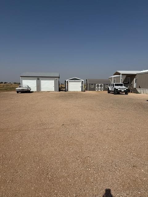 view of yard featuring an outbuilding and a garage