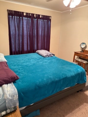 bedroom featuring ornamental molding, carpet flooring, and ceiling fan