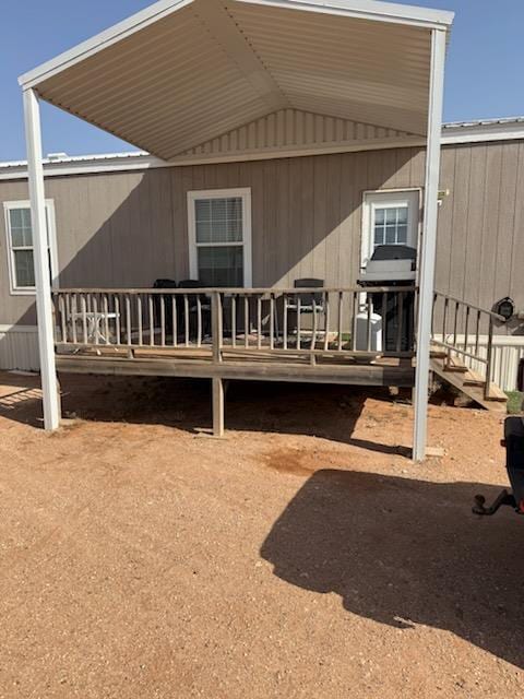 rear view of property with a wooden deck