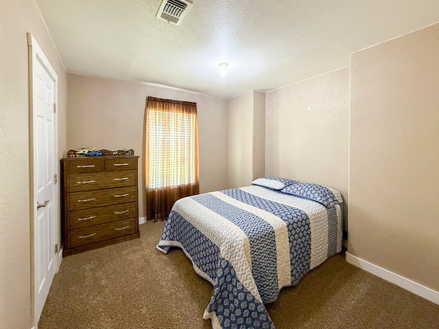 305 County Rd 306, Seminole, TX 79360 - carpeted bedroom featuring baseboards and a textured ceiling