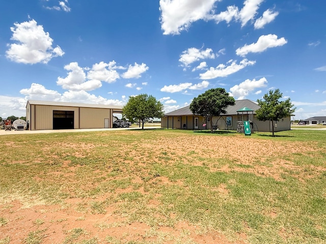 305 County Rd 306, Seminole, TX 79360 - view of grassy yard with a detached garage, a pole building, and an outbuilding