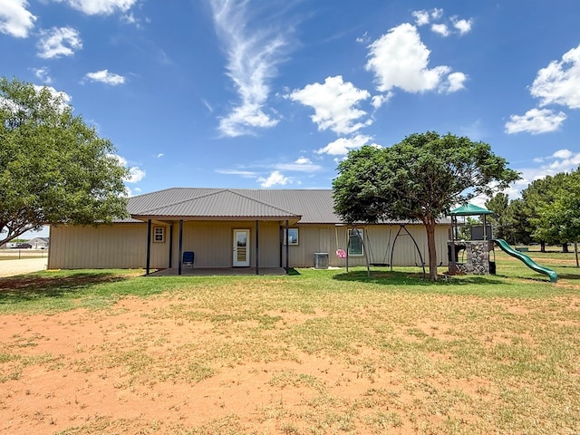 305 County Rd 306, Seminole, TX 79360 - back of house featuring a lawn, a playground, and a metal roof