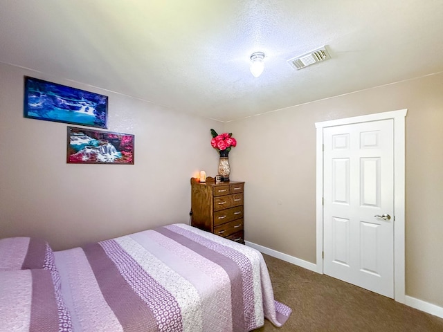 305 County Rd 306, Seminole, TX 79360 - carpeted bedroom featuring baseboards and a textured ceiling