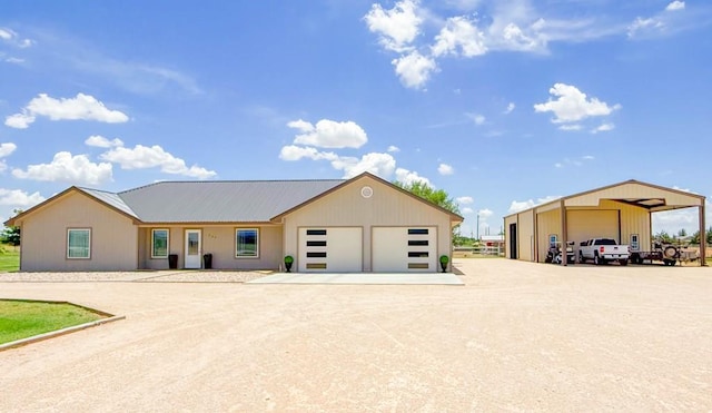 305 County Rd 306, Seminole, TX 79360 - view of front of home featuring a garage, a metal roof, and driveway