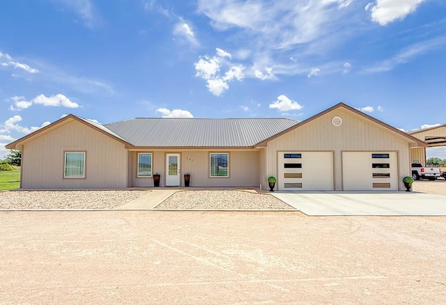 305 County Rd 306, Seminole, TX 79360 - view of front of property featuring a garage, a metal roof, and concrete driveway