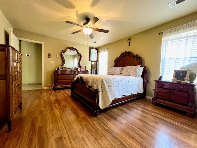 3717 S County Rd 1314, Odessa, TX 79765 - bedroom featuring dark wood-style flooring, multiple windows, and ceiling fan