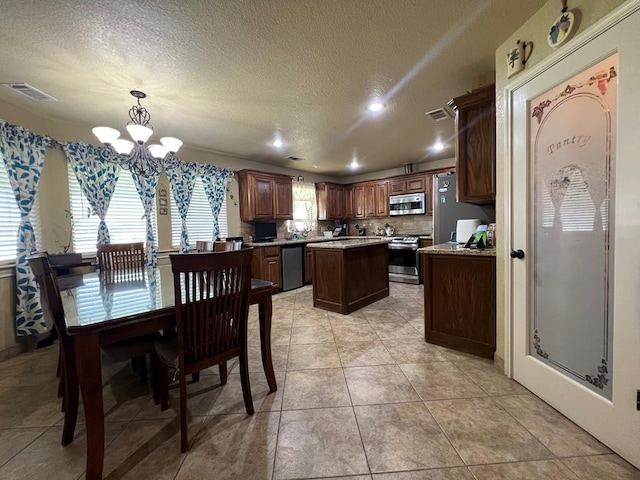 3717 S County Rd 1314, Odessa, TX 79765 - dining room featuring recessed lighting, a textured ceiling, a chandelier, and light tile patterned flooring