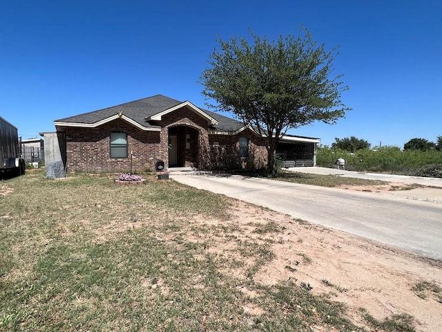 3717 S County Rd 1314, Odessa, TX 79765 - ranch-style home with brick siding, a shingled roof, and a front yard