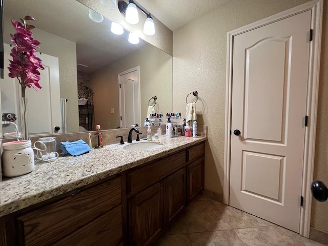 3717 S County Rd 1314, Odessa, TX 79765 - bathroom featuring a textured wall, vanity, and tile patterned floors
