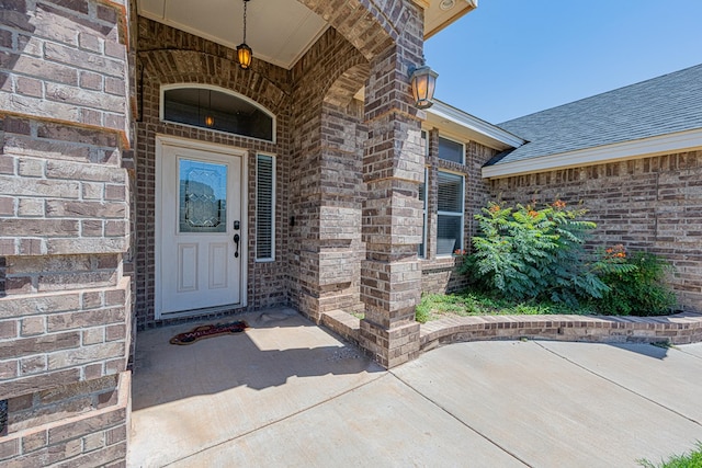 10901 E County Rd 108, Midland, TX 79706 - view of exterior entry with brick siding and roof with shingles