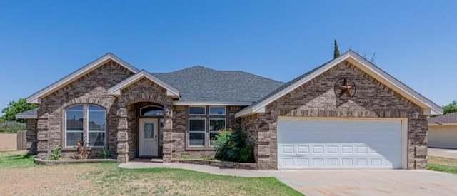 10901 E County Rd 108, Midland, TX 79706 - view of front of property featuring brick siding, concrete driveway, and a garage