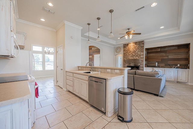10901 E County Rd 108, Midland, TX 79706 - kitchen featuring stainless steel dishwasher, a sink, a ceiling fan, a fireplace, and light countertops