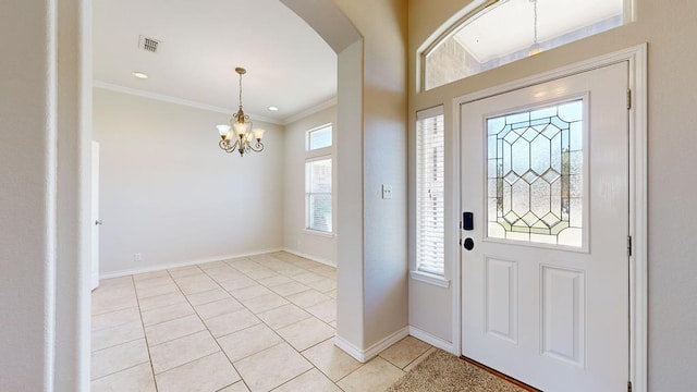 10901 E County Rd 108, Midland, TX 79706 - foyer entrance featuring arched walkways, a chandelier, light tile patterned flooring, baseboards, and ornamental molding