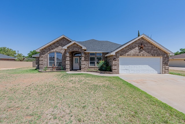 10901 E County Rd 108, Midland, TX 79706 - view of front facade featuring an attached garage, concrete driveway, brick siding, and roof with shingles