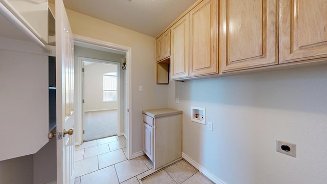 10901 E County Rd 108, Midland, TX 79706 - washroom featuring electric dryer hookup, hookup for a washing machine, cabinet space, light tile patterned floors, and baseboards