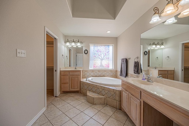 10901 E County Rd 108, Midland, TX 79706 - full bath featuring a bath, a spacious closet, tile patterned floors, and two vanities