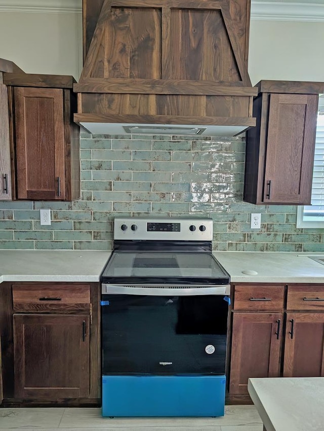 9 Prairie View Ln, Alpine, TX 79830 - kitchen with stainless steel electric range, custom range hood, crown molding, decorative backsplash, and light countertops