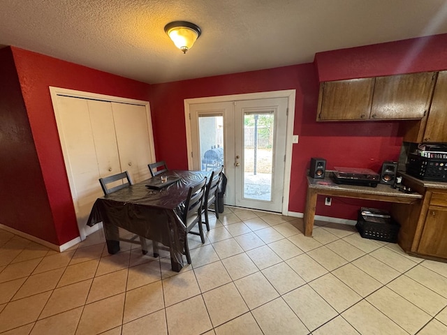 4417 Redbud Ave, Odessa, TX 79762 - dining room with baseboards, french doors, a textured ceiling, an office area, and light tile patterned floors