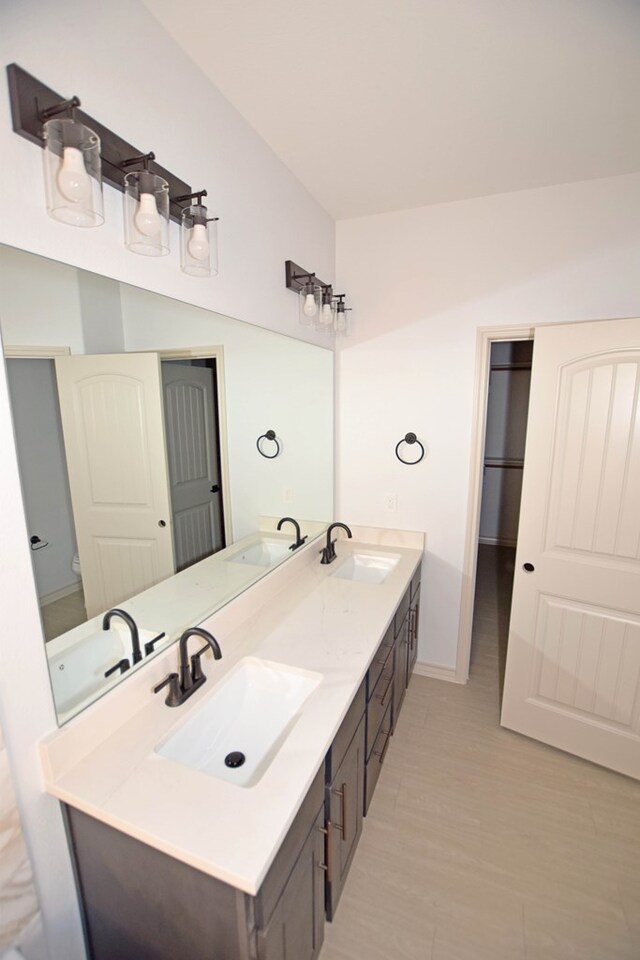 8639 Fortuna Ct, Odessa, TX 79765 - bathroom featuring double vanity and baseboards