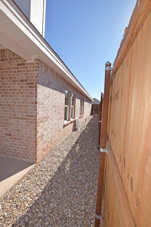 8639 Fortuna Ct, Odessa, TX 79765 - view of side of home featuring brick siding