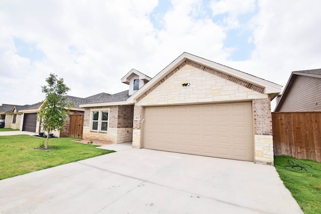 8639 Fortuna Ct, Odessa, TX 79765 - view of front facade with driveway, brick siding, a garage, and stone siding