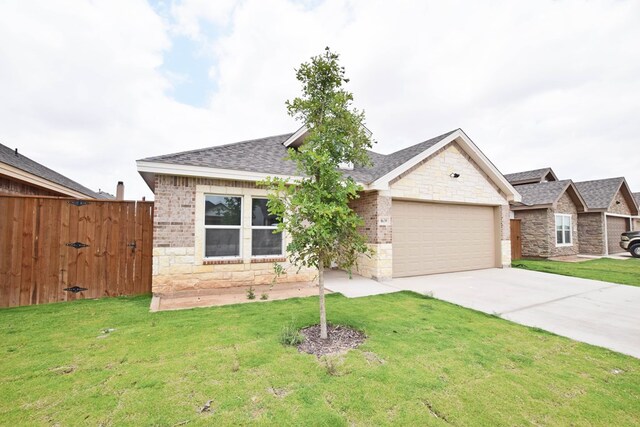 8639 Fortuna Ct, Odessa, TX 79765 - view of front facade with stone siding, an attached garage, driveway, and a shingled roof