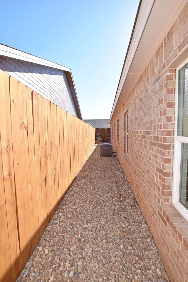 8639 Fortuna Ct, Odessa, TX 79765 - view of side of property with brick siding and central AC unit