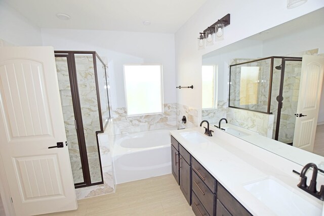 8639 Fortuna Ct, Odessa, TX 79765 - full bathroom featuring a bath, a stall shower, and double vanity