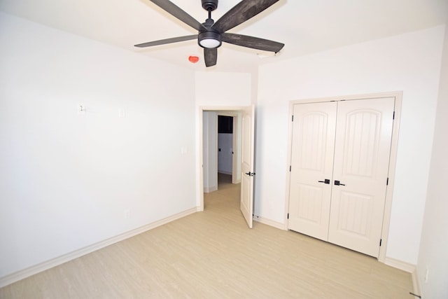 8639 Fortuna Ct, Odessa, TX 79765 - unfurnished bedroom featuring light wood-style flooring, a closet, baseboards, and a ceiling fan