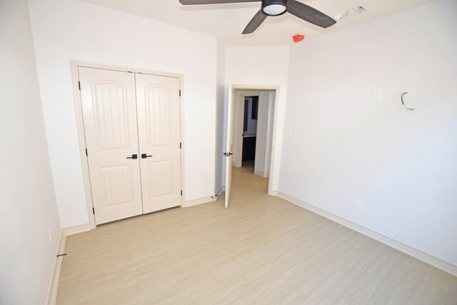 8639 Fortuna Ct, Odessa, TX 79765 - unfurnished bedroom with light wood-style floors, a closet, baseboards, and a ceiling fan